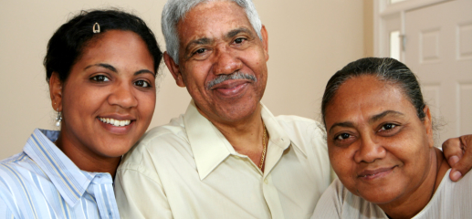 caregiver and elderly couple smiling